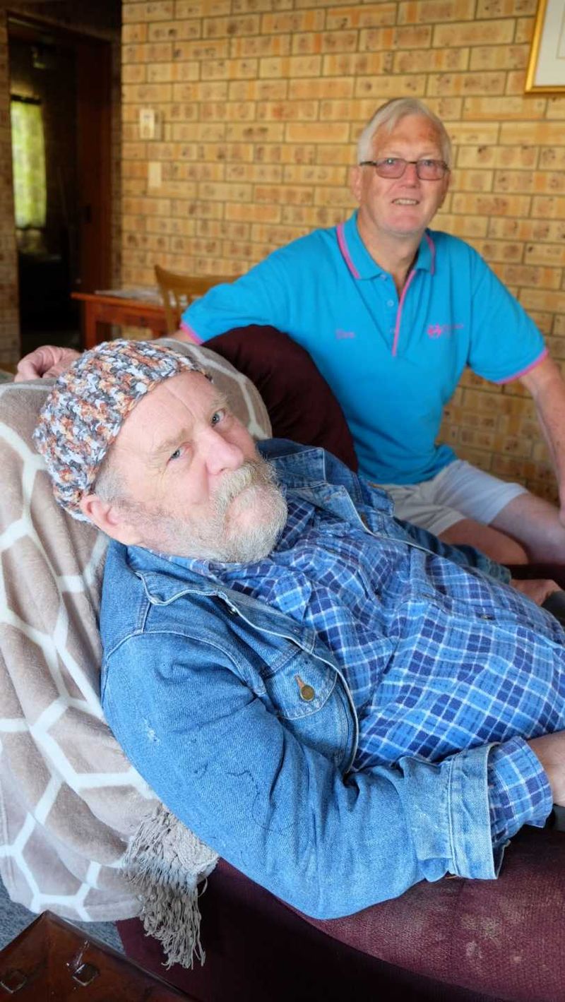 Mark McShane modelling one of the beanies donated to Meals on Wheels by the QCWA pictured with volunteer Don Collins