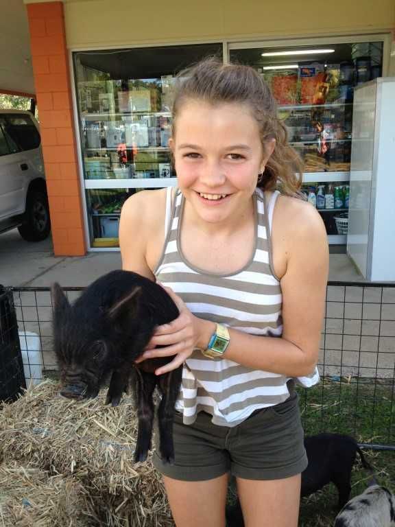Kate Gilmore holds one of the main draw cards of the day: a cute miniature pig from Peak Pig Racing