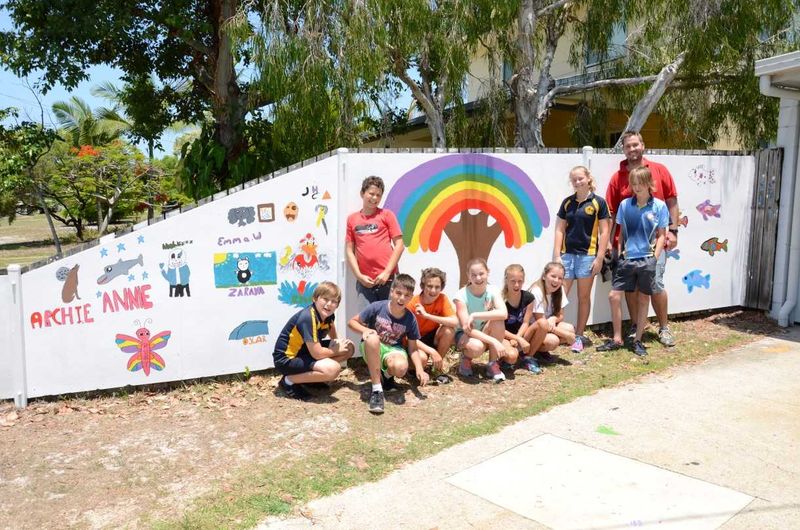 Michael Grogan with Year 6 students and their new mural at Rainbow Beach Police Beat