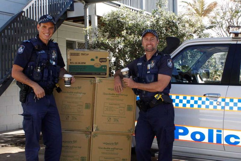 Local officers Mike Brantz and Mick Emery get ready to distribute the anti-domestic voilence coffee cups
