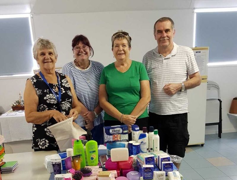 QCWA Member Joan, Debbie, Dawn and Mark with some of the Care Pack items