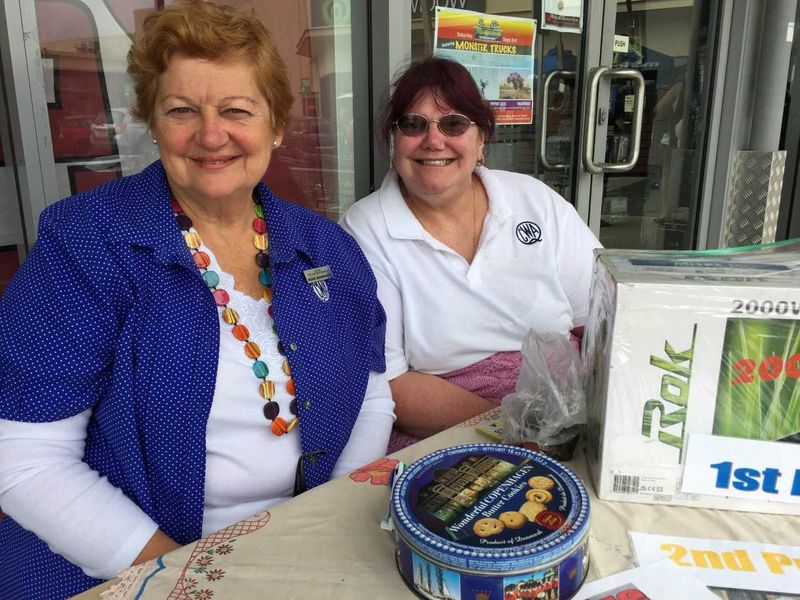 Irene Manwaring and Debbie Vines selling QCWA raffle tickets