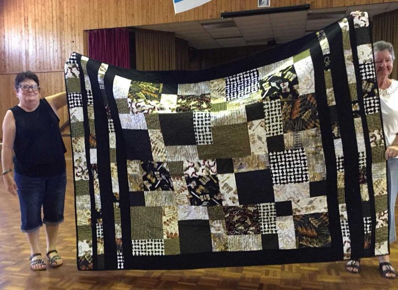 Leonie proudly displays her Layer Cake quilt