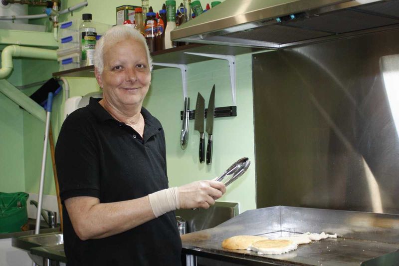 Clair Picot is cooking up burgers at Rainbow Beach Fruit