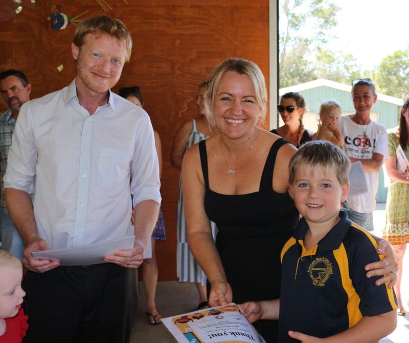 President of the School P &amp; C Jed Elmer congratulating Tessia’s and James Fitzgerald. James sold his own drawings to rais