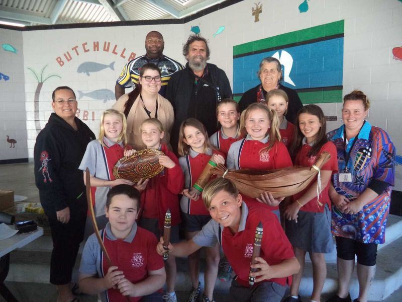 NAIDOC Day Photo Attached – Community Elders with some of the students learning about the bush tucker and artifacts.