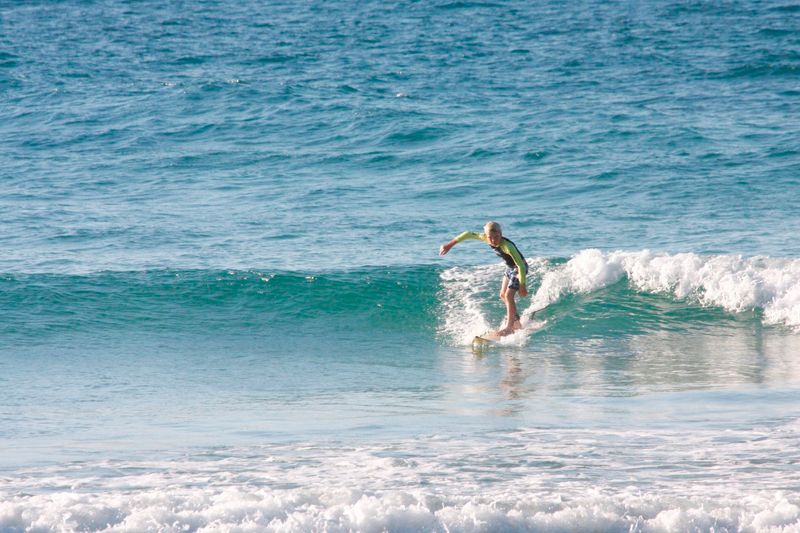 10-year-old Seth Parton surfs at Double Island Point
