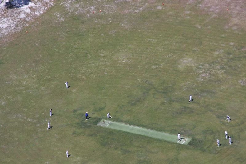 Although it is amazing to see Rainbow Beach Cricket Club play from the sky, (taken from Rainbow Beach Helicopters), the local