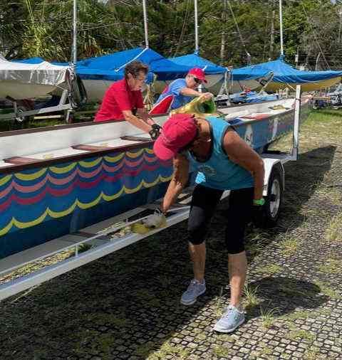 Cleaning the brightly coloured boats after being out on the water