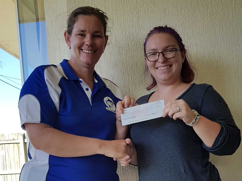 Cooloola Coast Little Athletics Centre Manager, Jess Milne recieves the donation from Chamber of Commerce President Bianca Ha