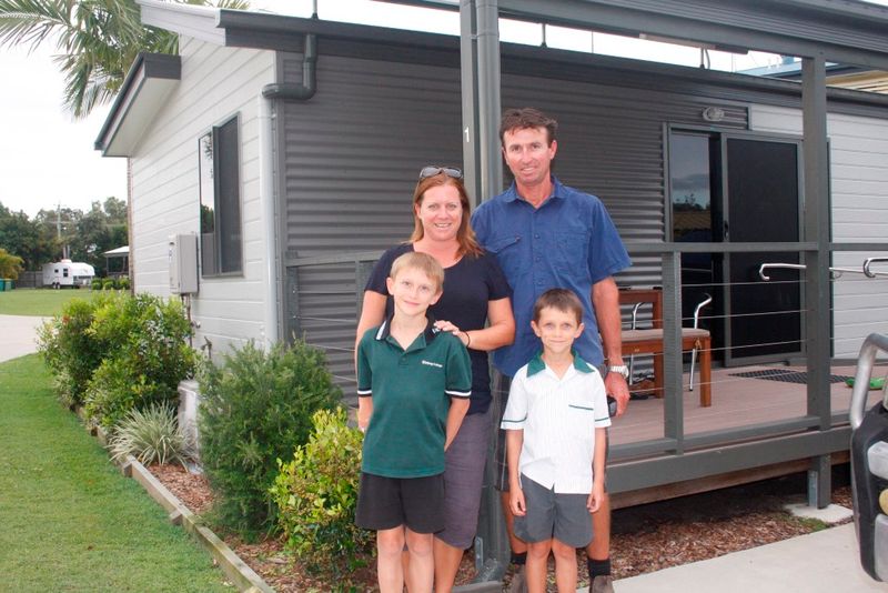 Melanie and Steve May with sons Thomas and Jackson outside one of their cabins, growing in number at the Tin Can Bay Tourist
