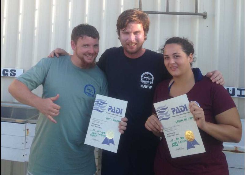 James from Wolf Rock Dive (centre) congratulates Scott Higham and Crystal-Lee Lewis who completed the PADI Open Water Course