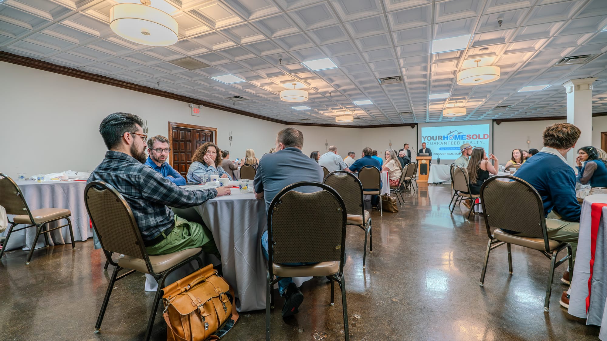 YHSGR Kings of Real Estate branded slide on screen during Town Hall meeting