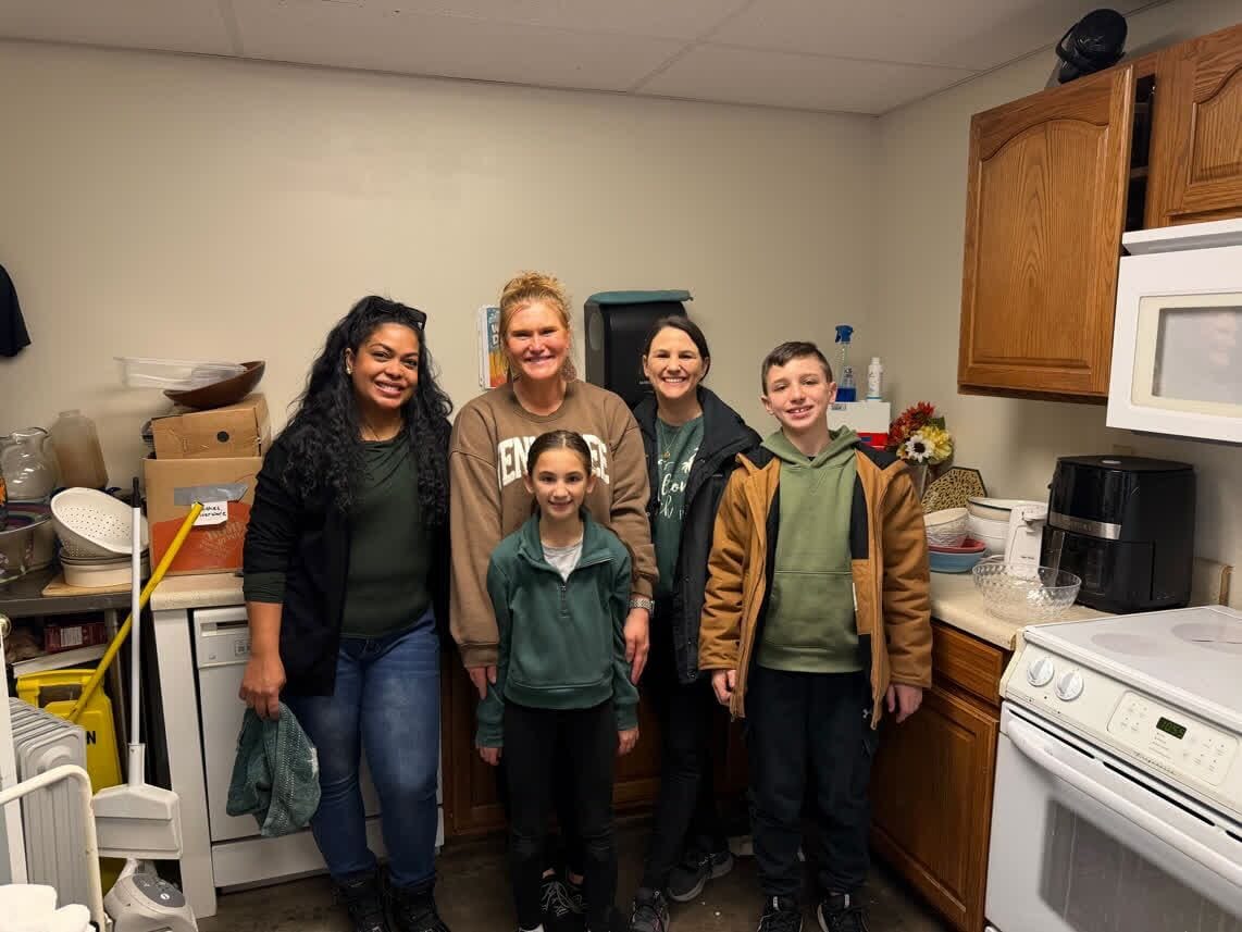 Volunteers and families in the LIVE-IT kitchen