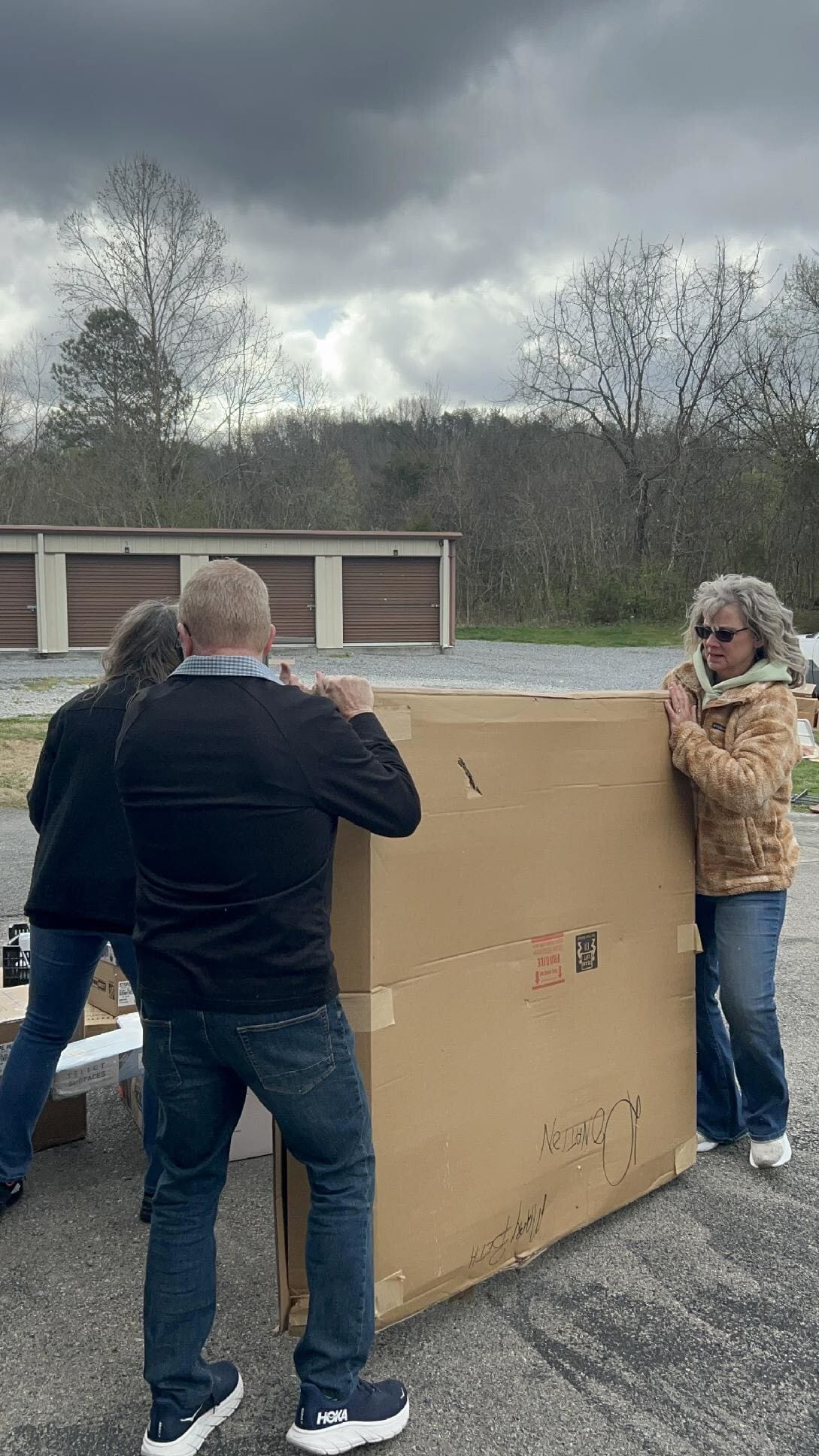 Volunteers carrying large donated boxes at LIVE-IT Ministries