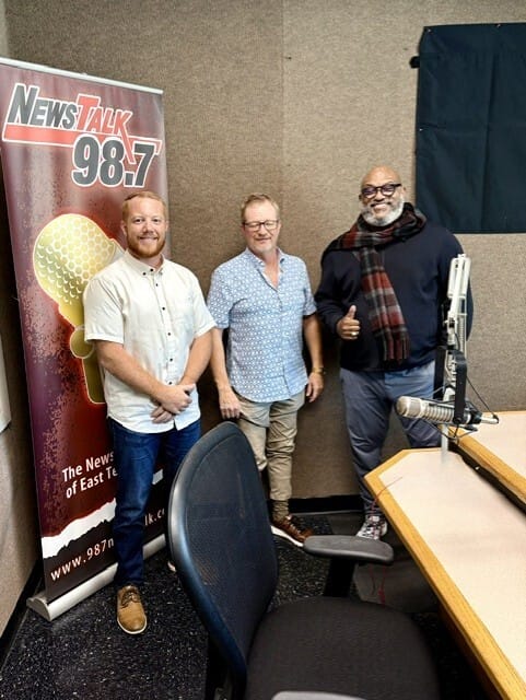 Tannor Giles, Tracy King, and Hallerin Hilton Hill posing together at the NewsTalk 98.7 WOKI studio
