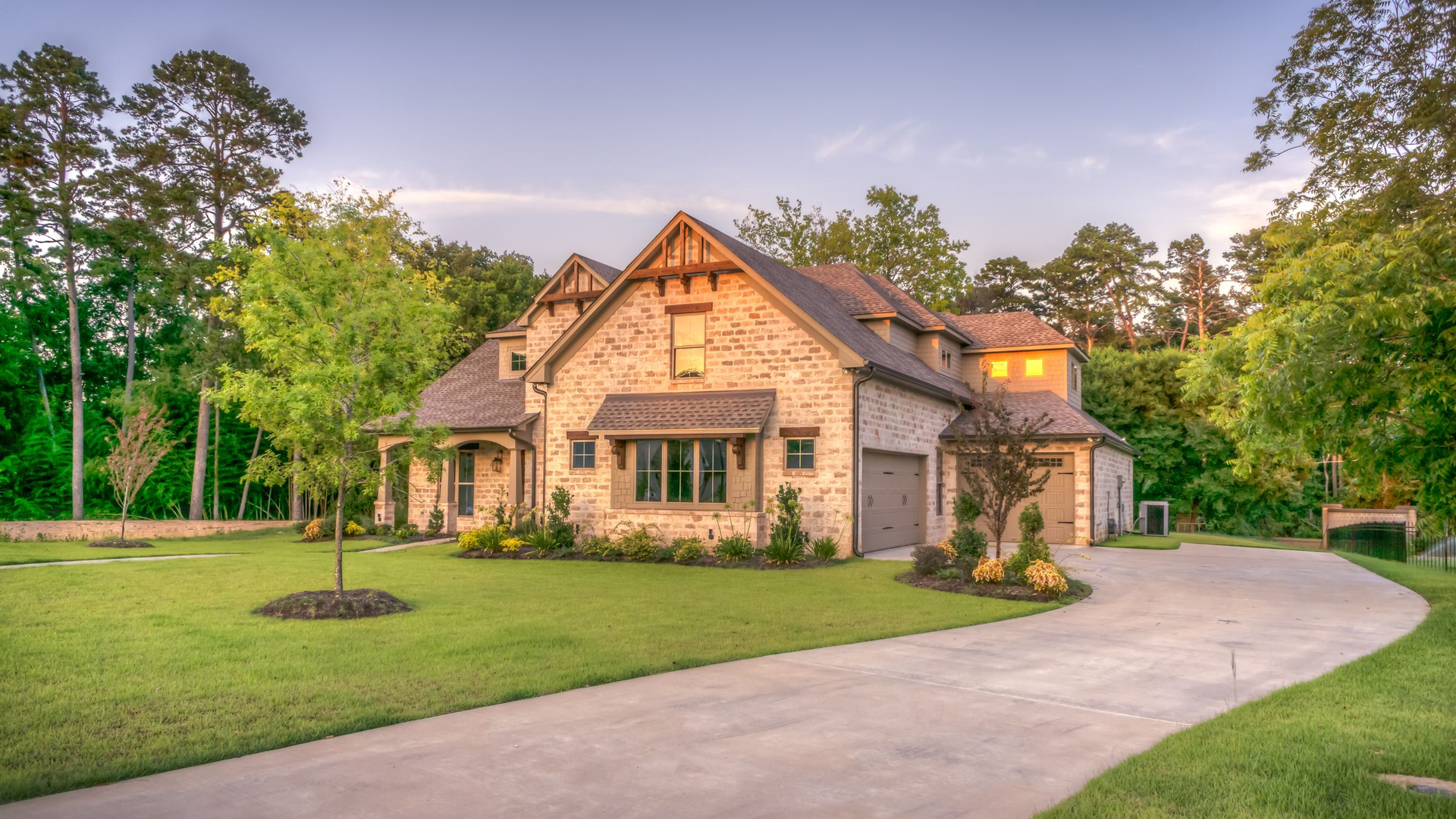 Photoreal stone-front single-family home with a curved driveway and young trees in East Tennessee, no people, logos, or text