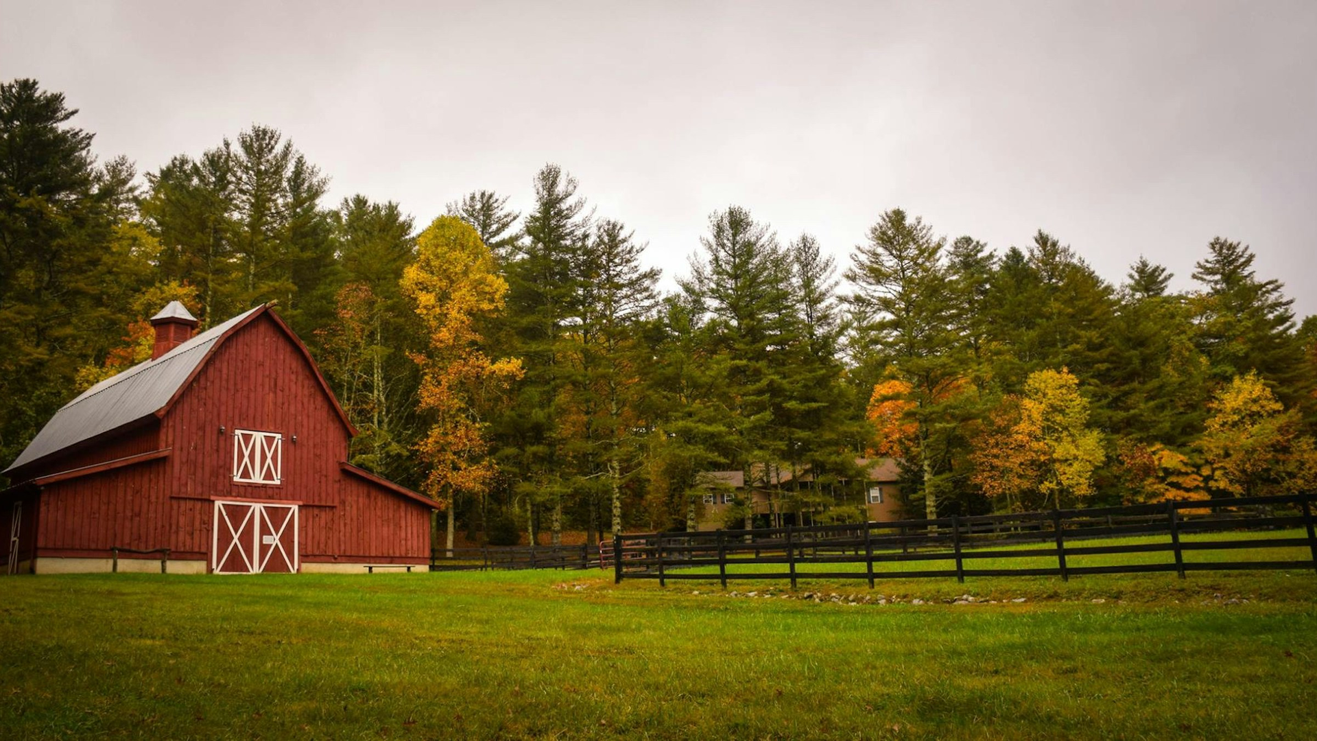 Photoreal red barn beside a green pasture framed by orange and gold fall trees in rural Northeast Tennessee, no people, logos, or text