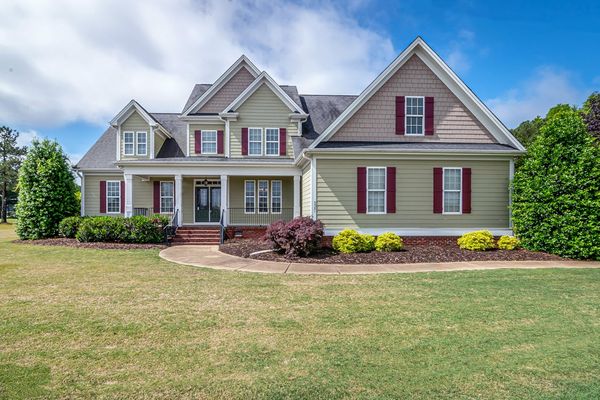 Beautiful two-story Tennessee home with manicured lawn and front porch — the kind of curb appeal that sells for top dollar