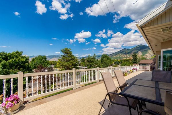 Empty Sevierville foothills house on a late-summer lawn with Smoky Mountain ridges, no people, logos, or text