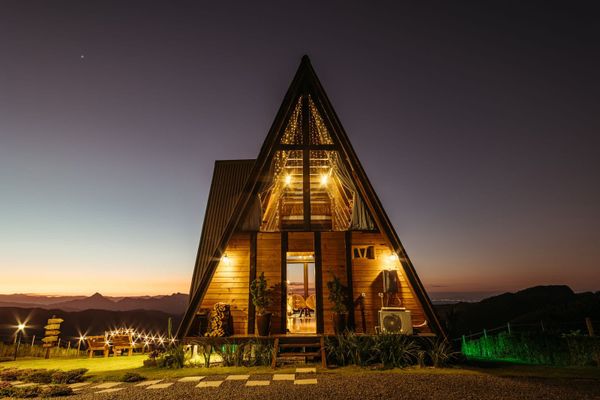 Photoreal Sevierville mountain-view home exterior at dusk, no people, logos, or text