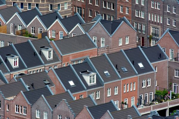 Aerial view of traditional Dutch townhouses in Den Haag, showcasing unique architecture.