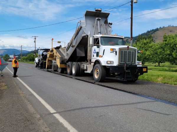 Paving equipment and crew working on road construction in Hood River, Oregon.