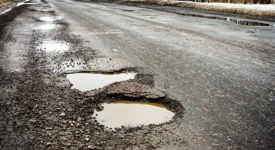 Close up image of potholes on a Michigan road.