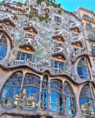 Photo of Casa Batlló in Barcelona, an ornate Gaudí-designed building with layered balconies, curved stonework, patterned facade details, and irregular windows. The image is used as a metaphor for the intricate architecture required to preserve plausible deniability in corrupt institutions.