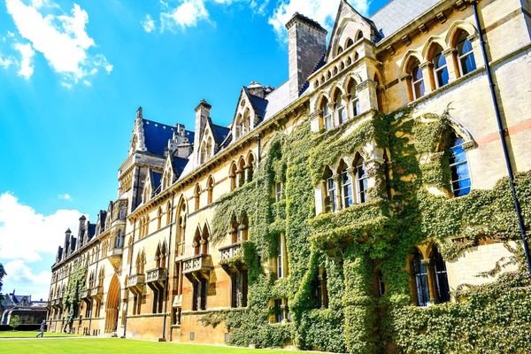 an ivy-covered university building on a quiet, landscaped campus
