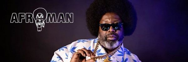 Afroman in sunglasses and a blue-and-white patterned shirt, posed against a dark background in a promotional profile image.