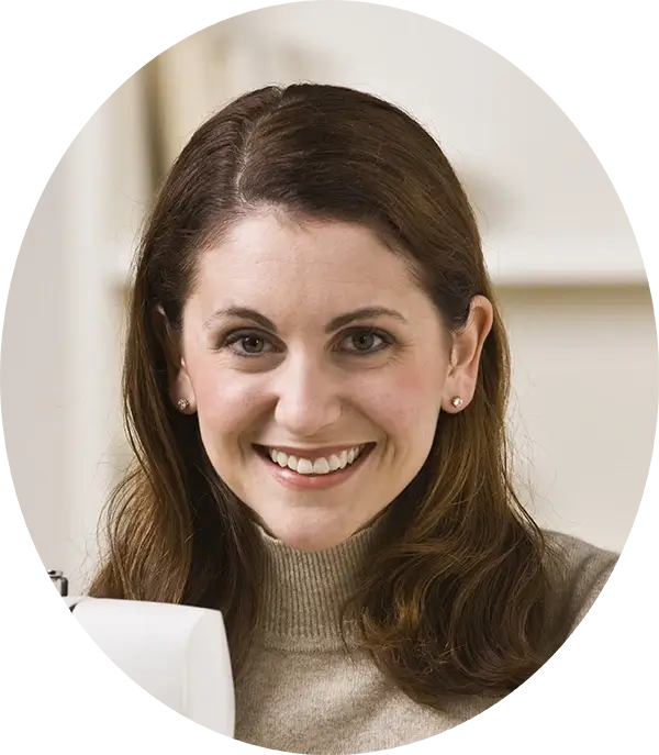 Author Annabelle Short looks at the camera, she is wearing a beige turtleneck and smiling