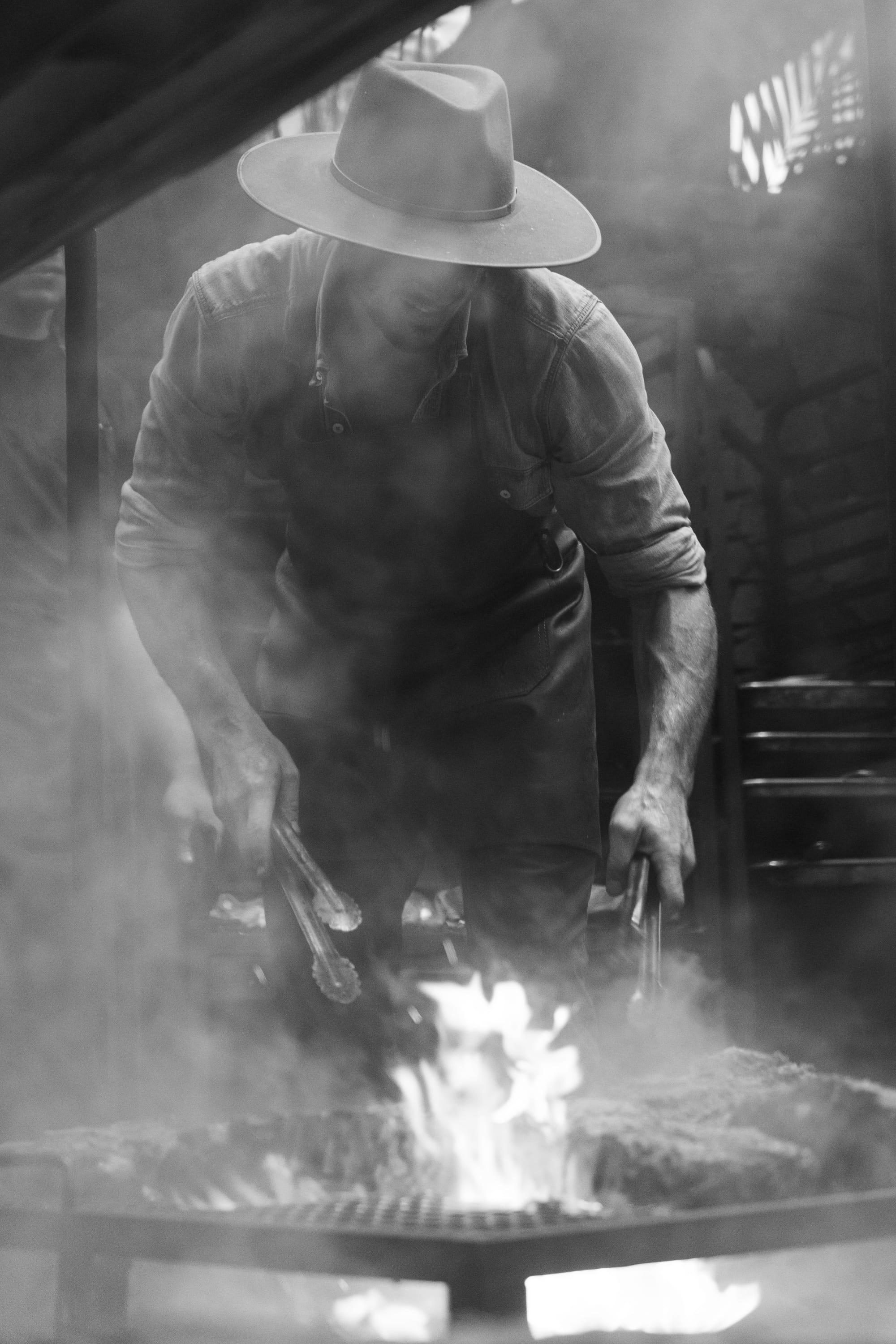 IMAGE: photo of Chef Stephen Moore and Chef Fran Benedicto Borges cooking at the fire — drag the image into Ghost here