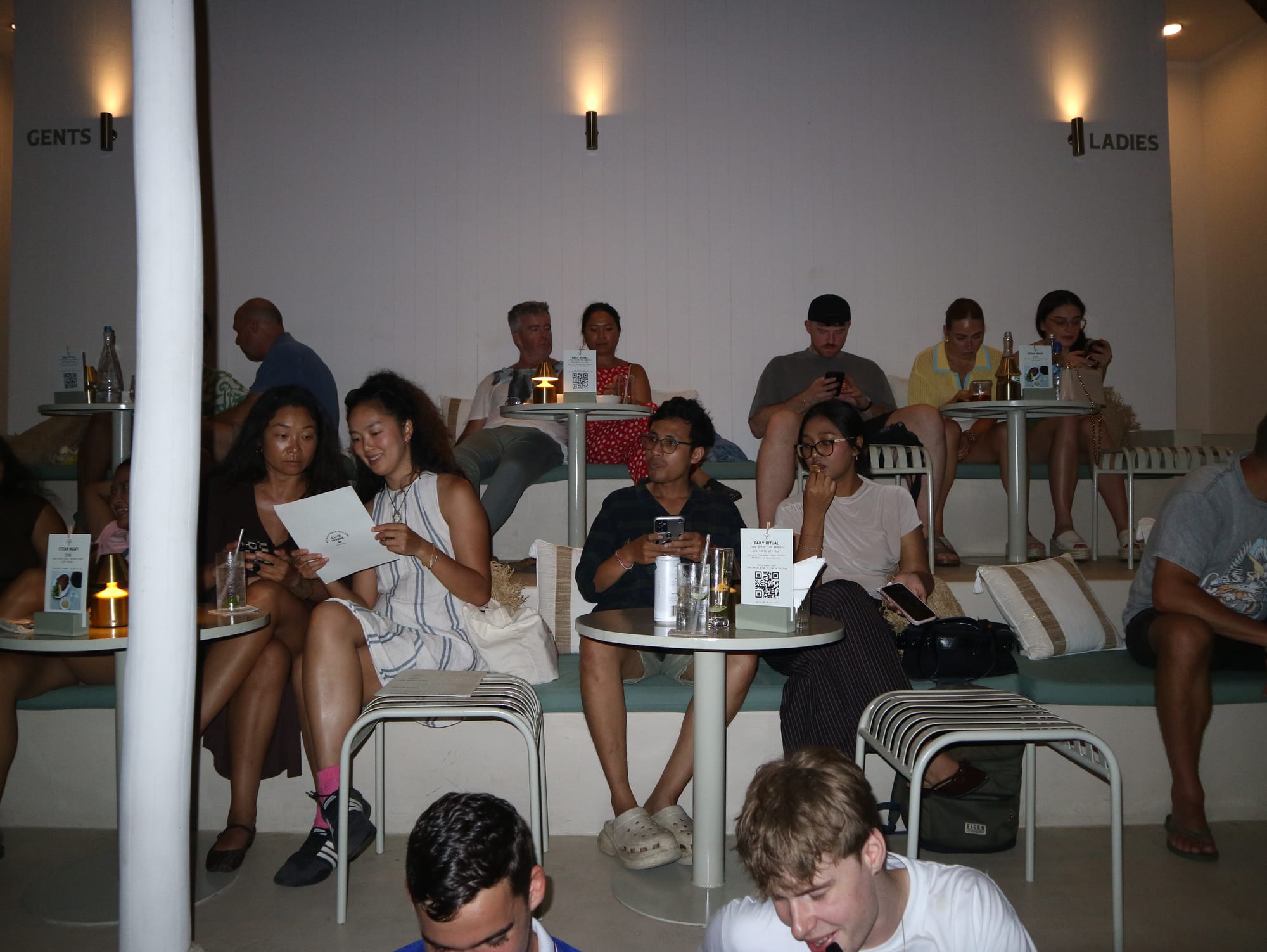 Guests competing in teams during Trivia Thursday at Club House Pererenan, with a full room of players at their tables