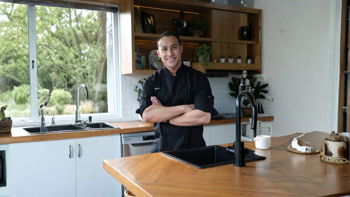 Chef Yuda Bustara posing in a chef's jacket, arms crossed