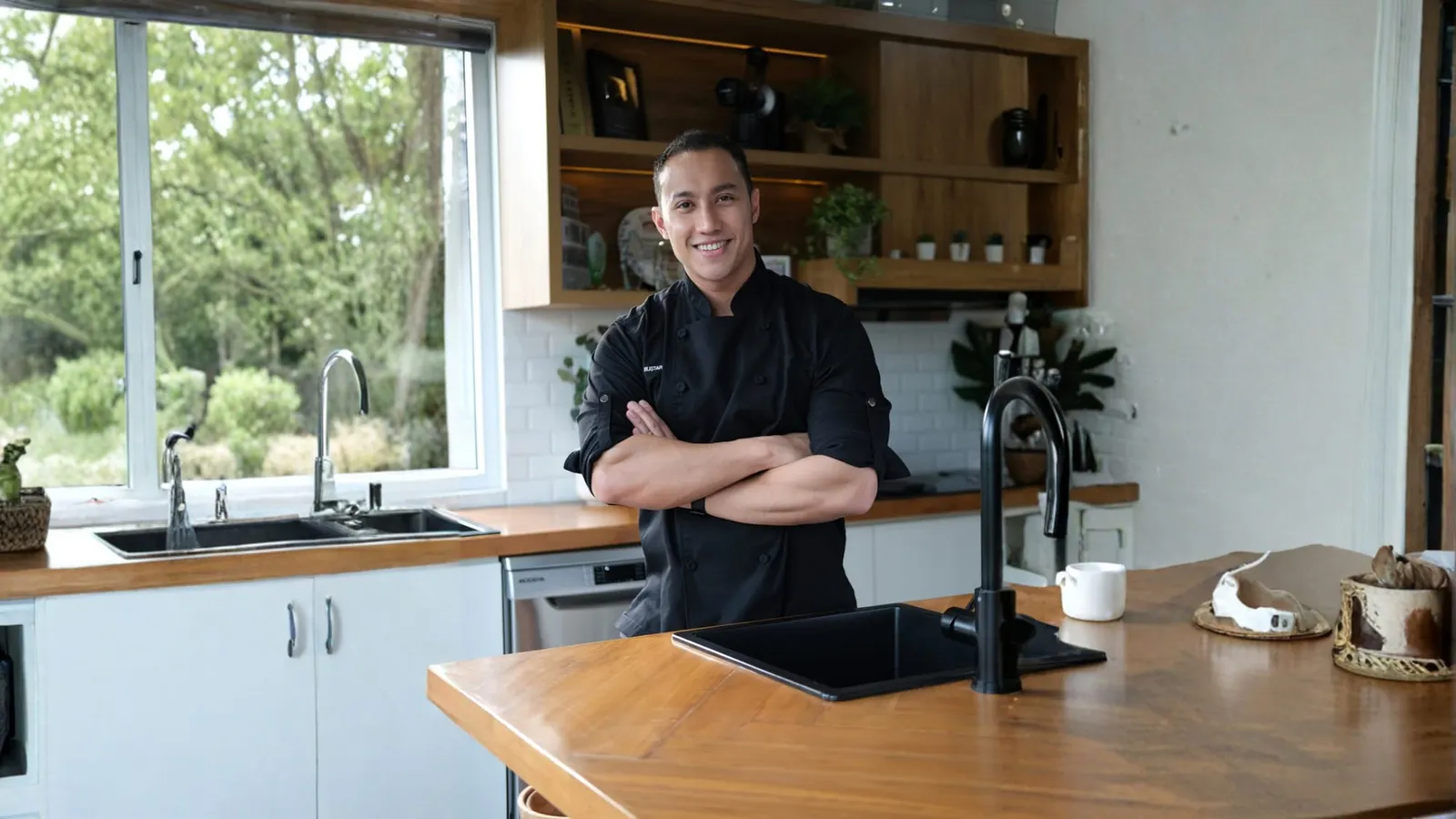 Chef Yuda Bustara posing in a chef's jacket, arms crossed