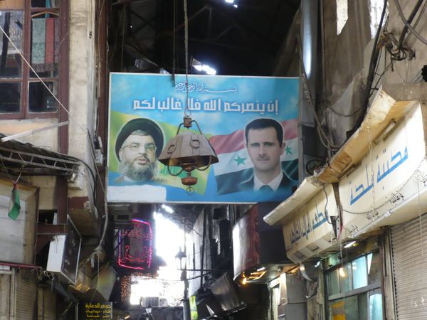 Political poster in a market of then Syrian President Bashar al-Assad and then Hezbollah leader Hassan Nasrallah of Lebanon