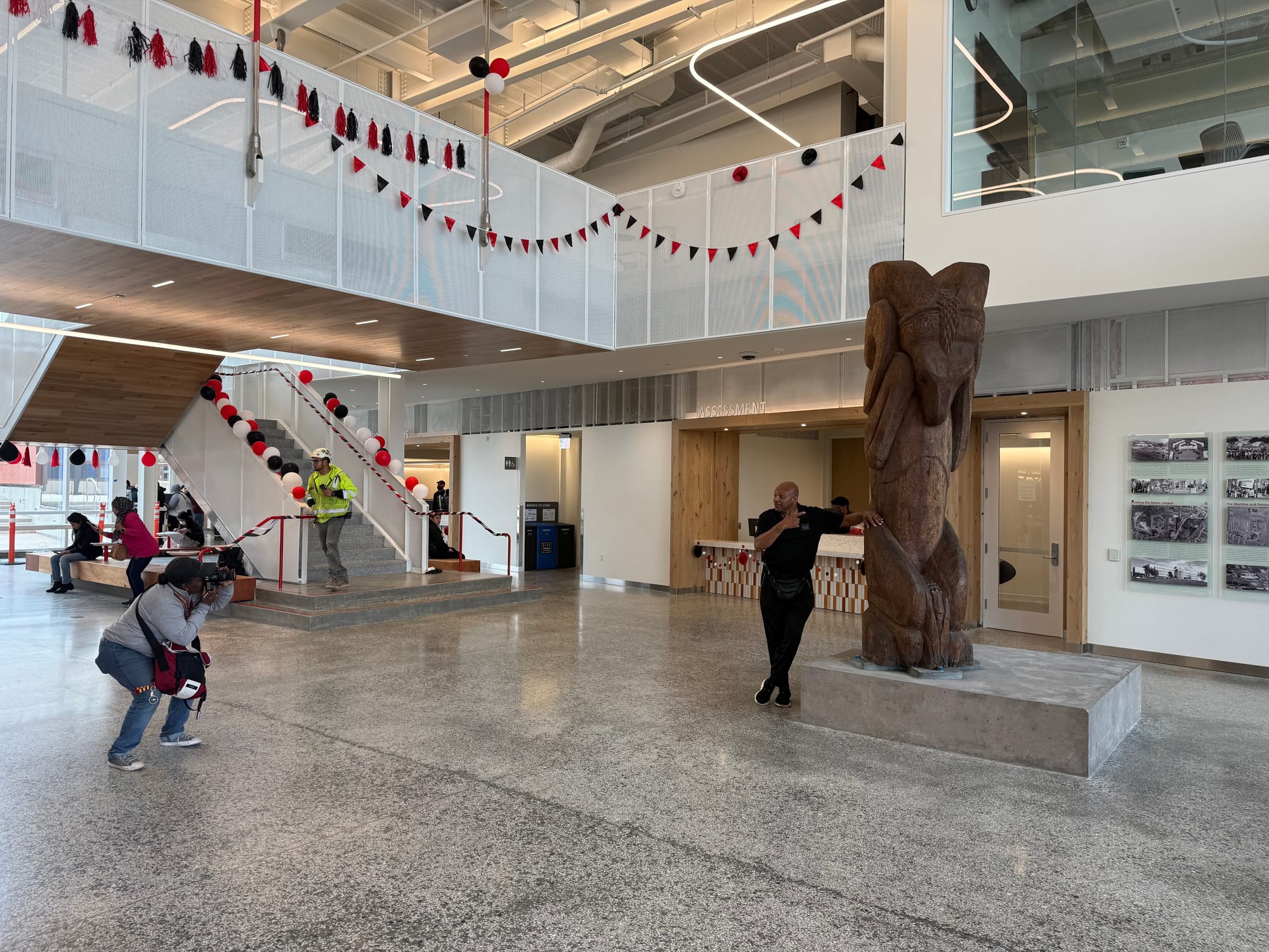 Photographer taking a picture of a man posing at a statue.