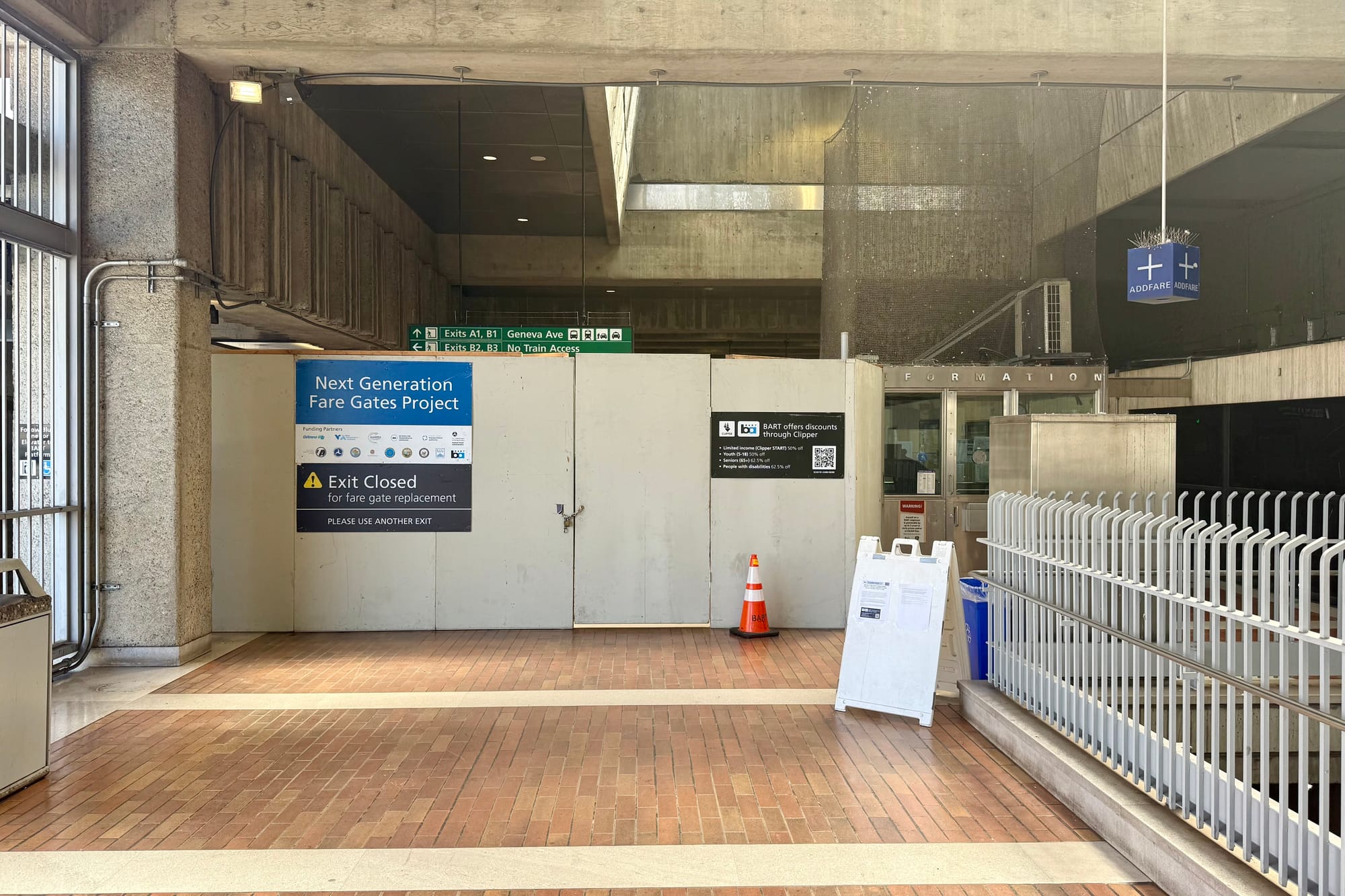Station concourse with construction barrier.