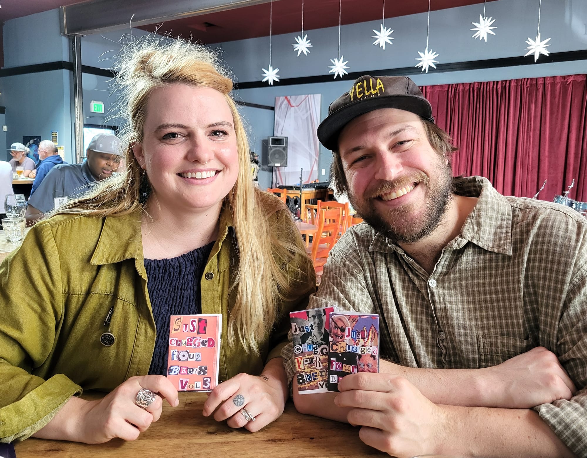 Couple holding zines.