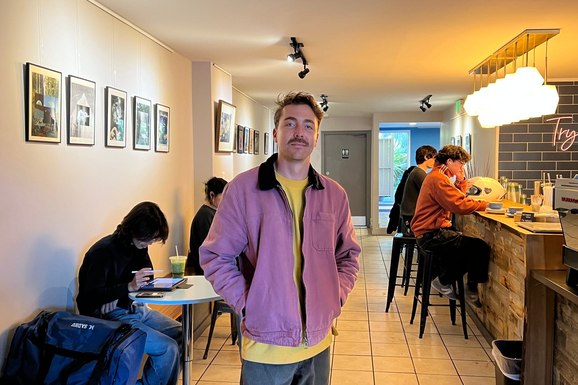 A man poses for a portrait in a cafe.