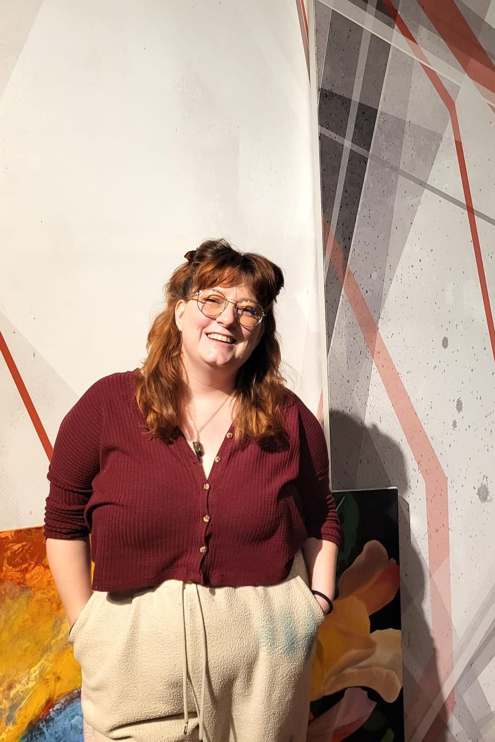 Woman with red hair posing for a picture.