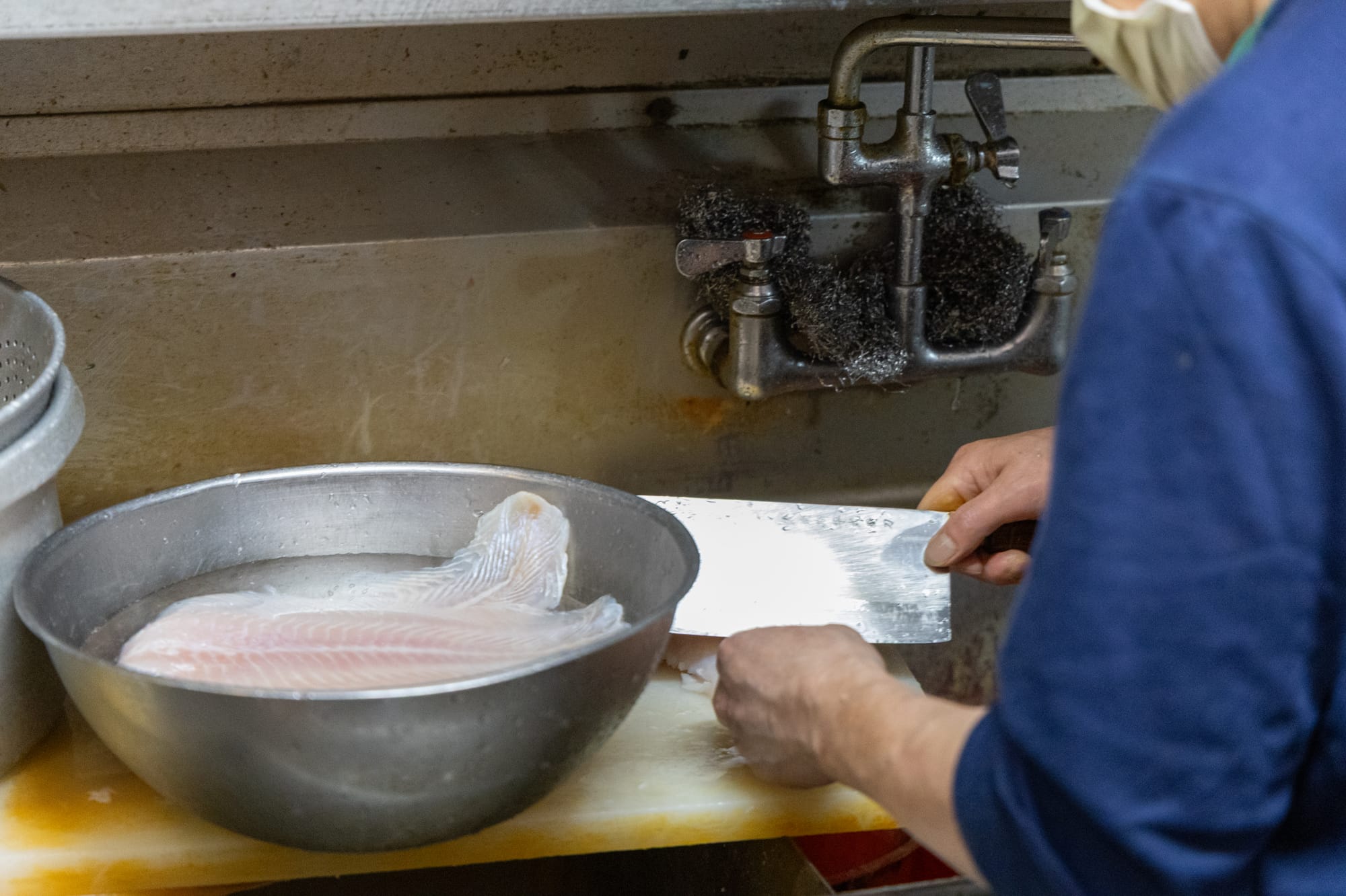 Man preps fish.