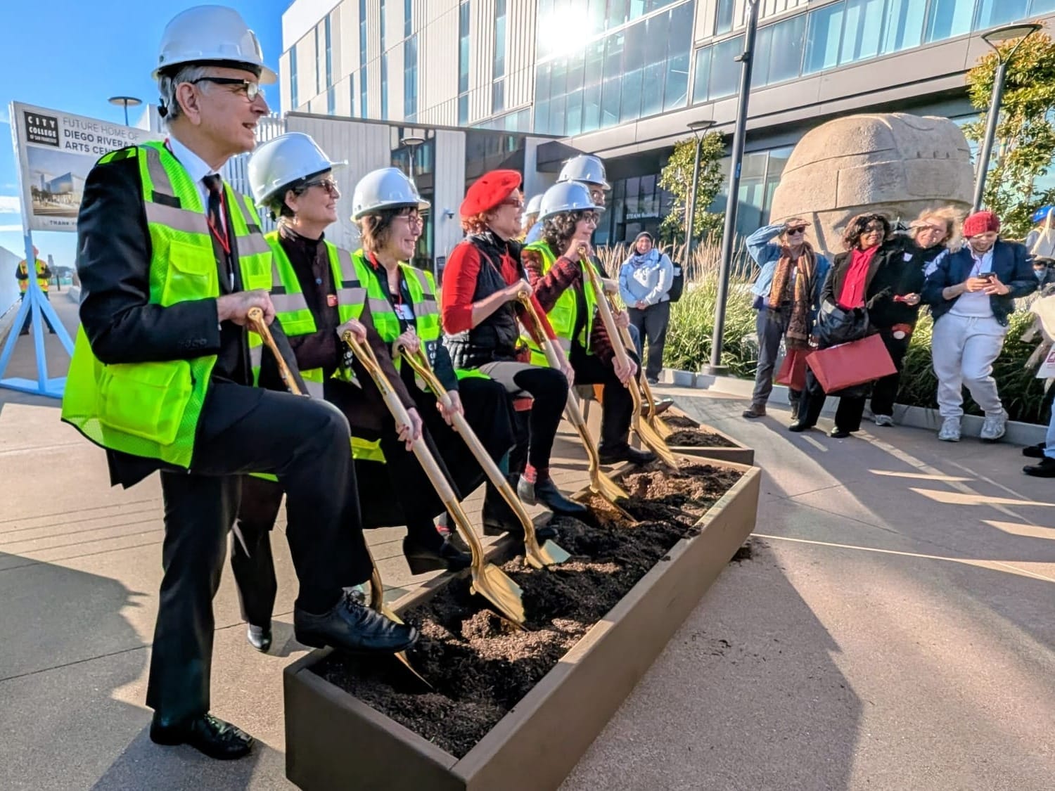 Officials with shovels.