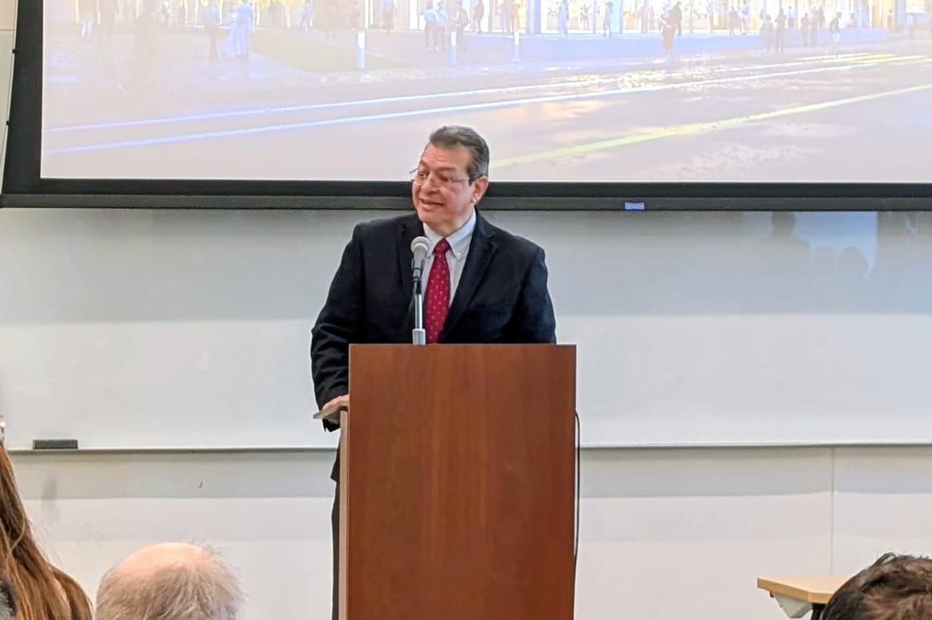 A man at a podium speaks.