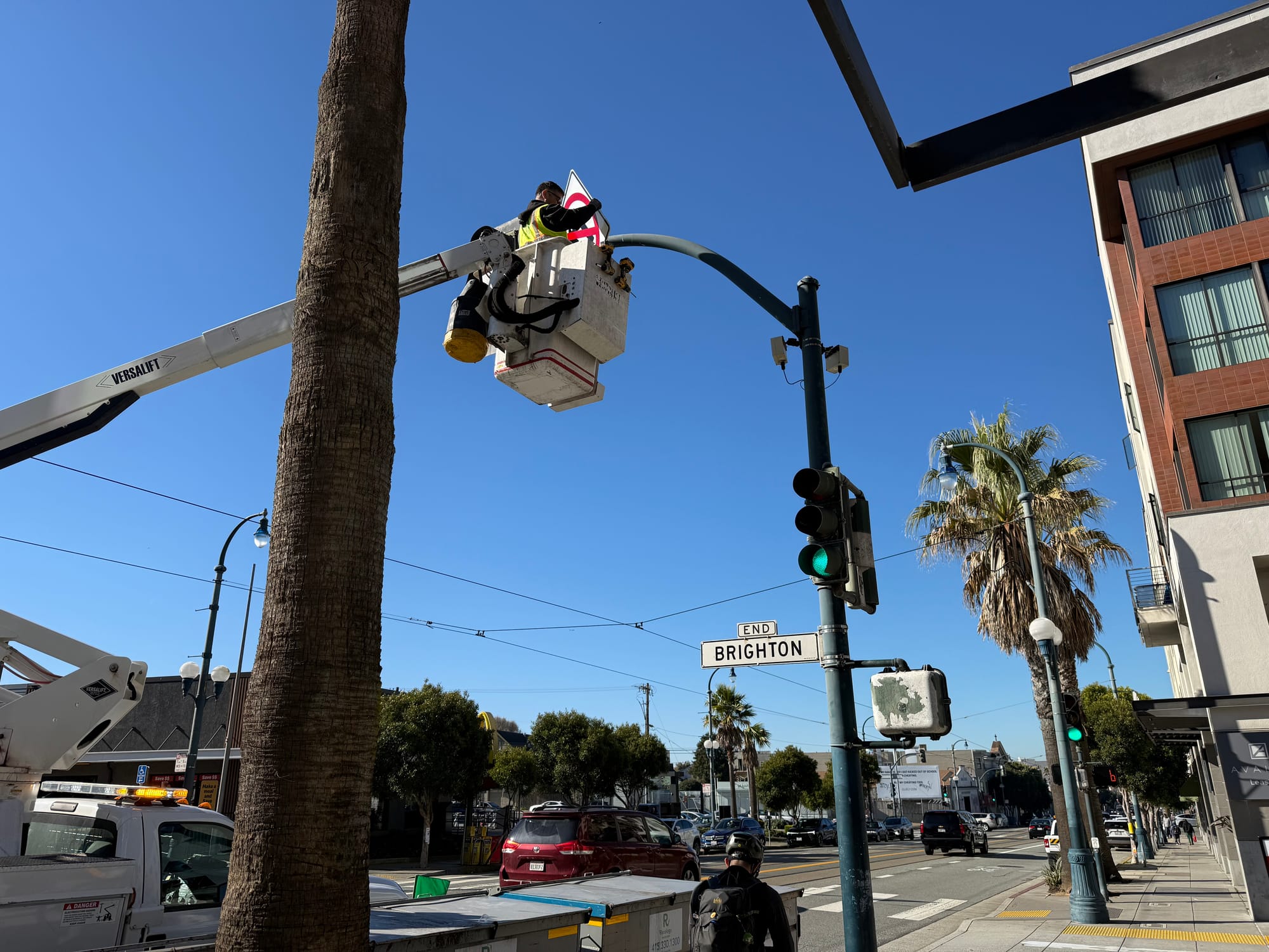 Man installs a sign.