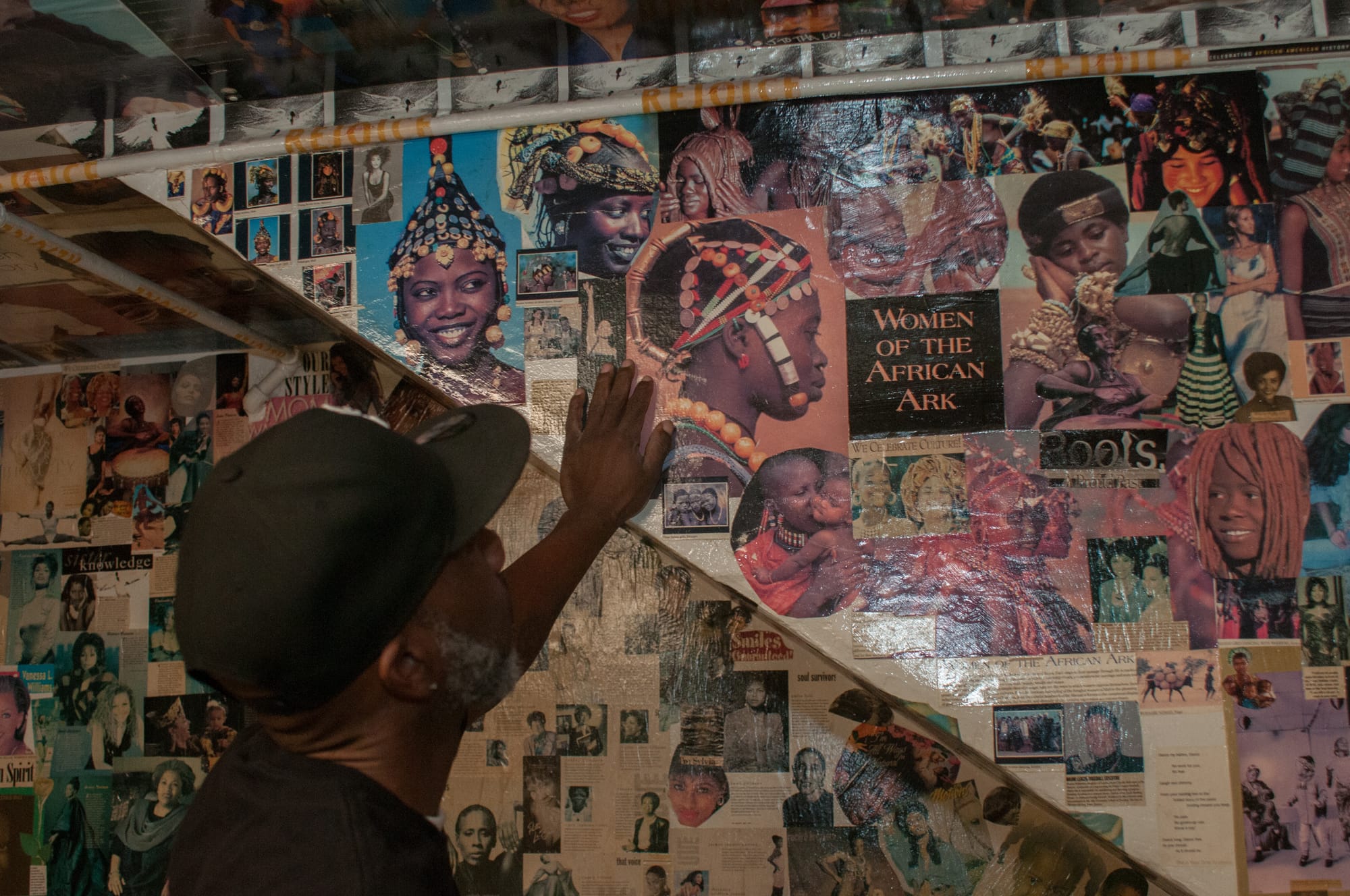 Man touches a collage.