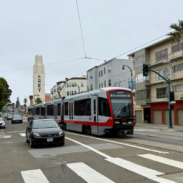 Two-car train on urban street.