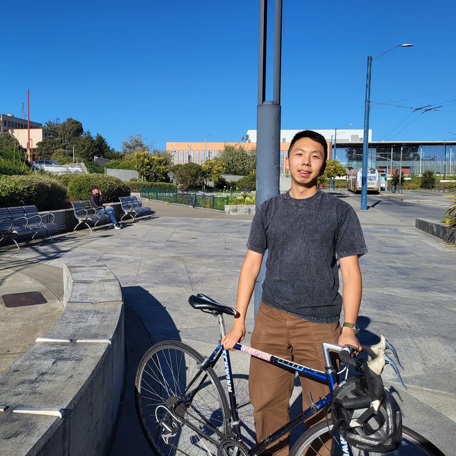 Man with bike in plaza.