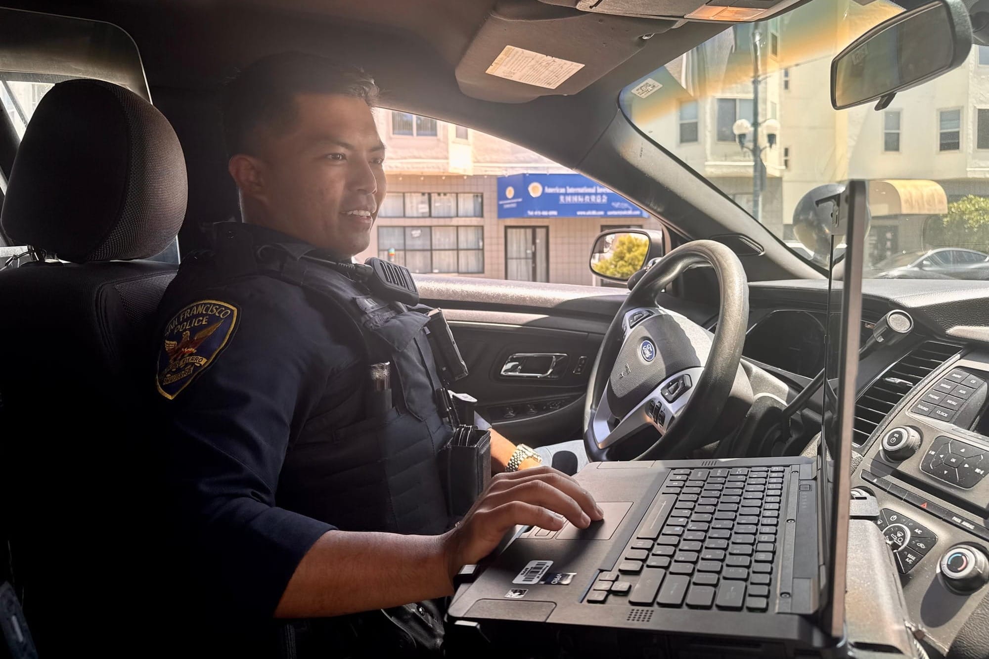 Officer at squad car computer.
